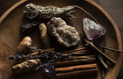 crystals and herbs on a wooden plate