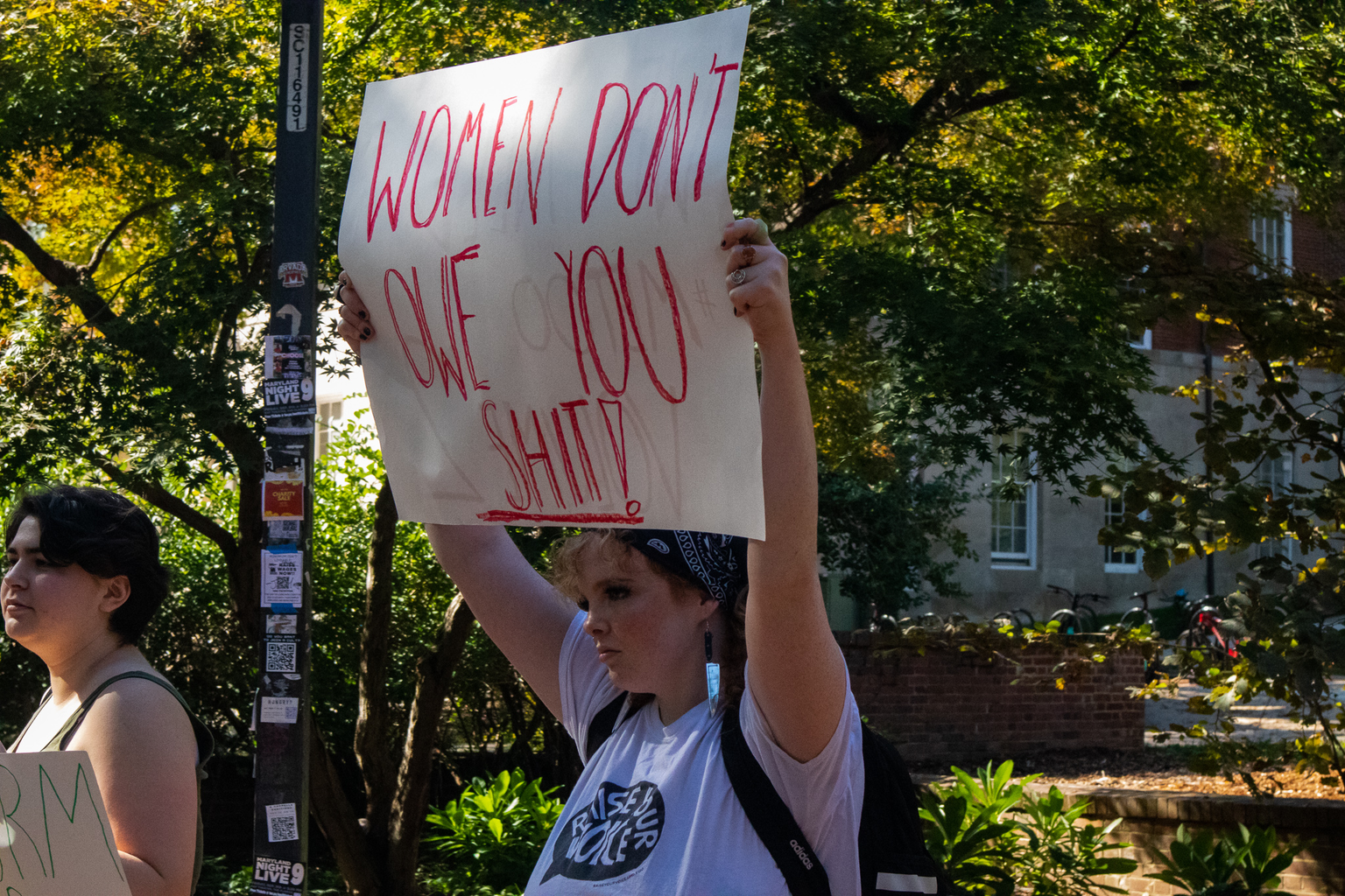 A woman holds up a sign at a protest