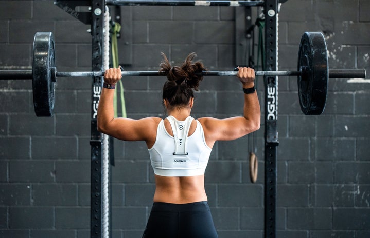 woman weightlifting in gym by Unsplash?width=719&height=464&fit=crop&auto=webp