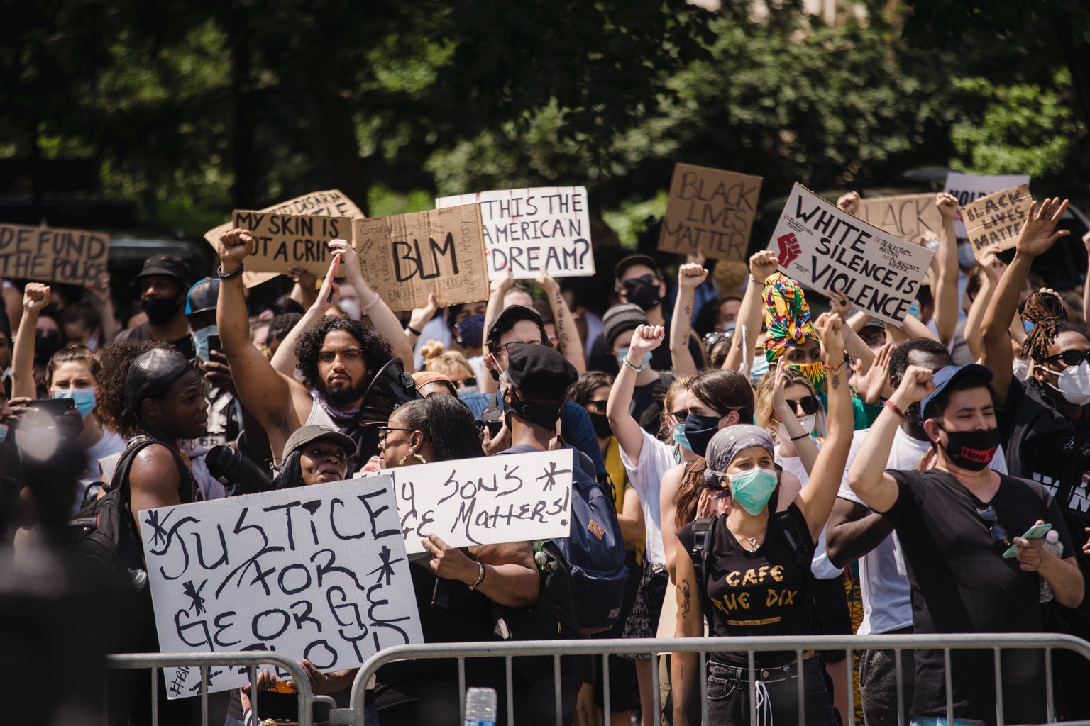 Crowd of protesters holding signs