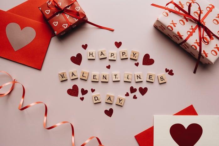 Happy Valentine\'s Day Text with gifts and confetti surrounding it