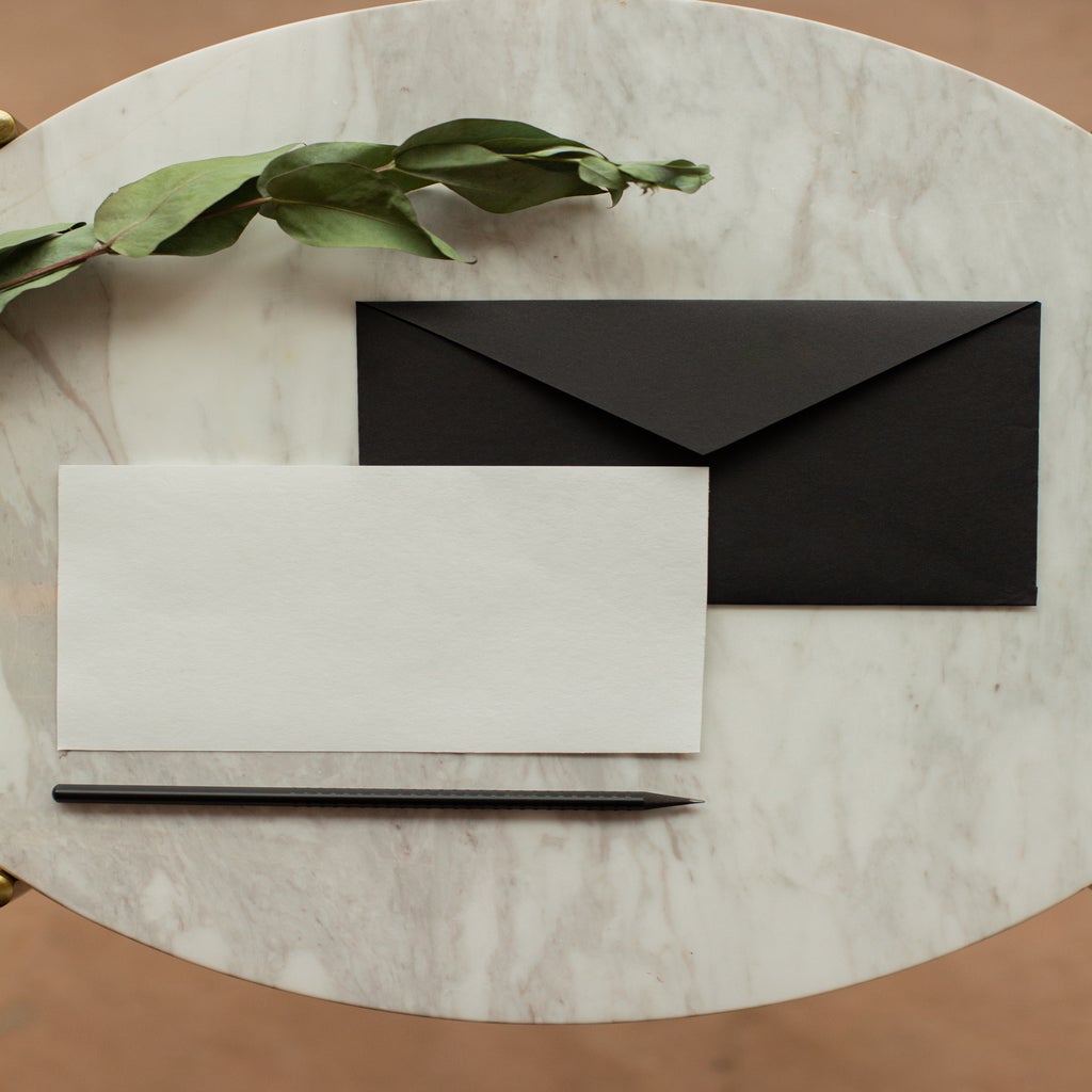 Blank letter paper with envelope near dried sprig