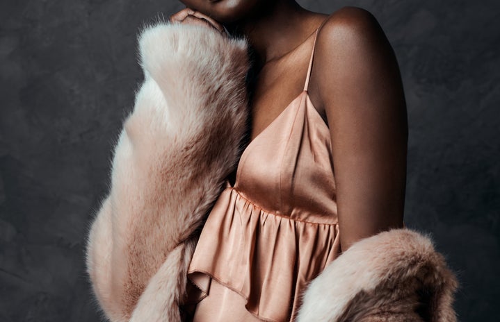 black model in a pink slip dress