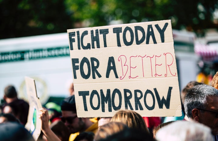protest sign that says "fight today for a better tomorrow"
