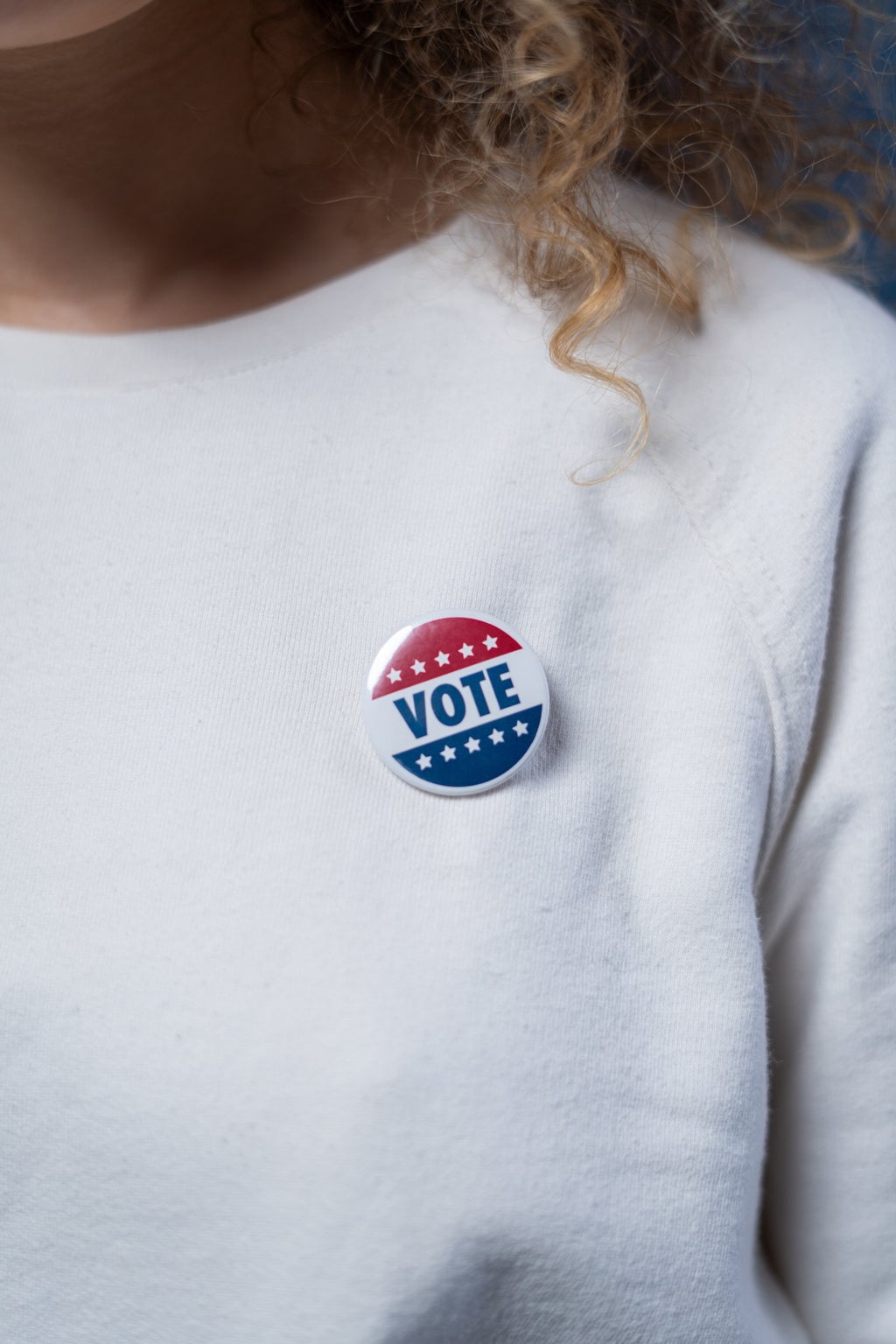 Vote Pin on a White Sweater