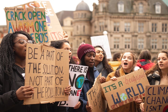 Women holding up climate change signs at a protest