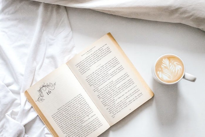 book with latte in bed