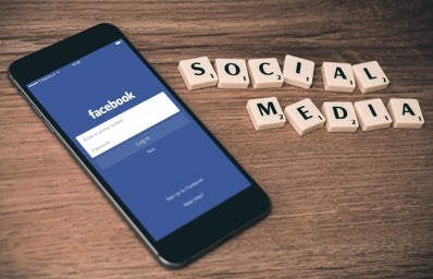 facebook login on phone with social media scrabble tiles