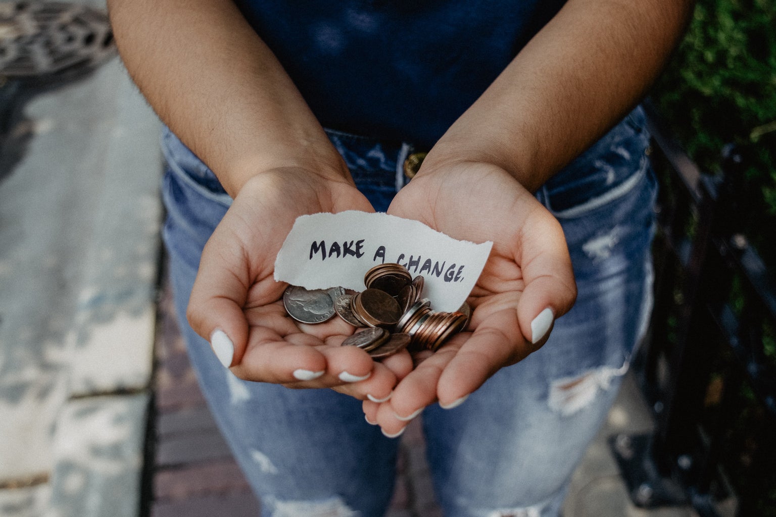 person holding coins and paper note in hands