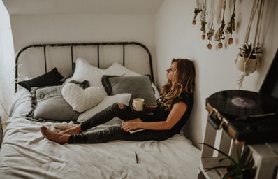 woman on bed with coffee