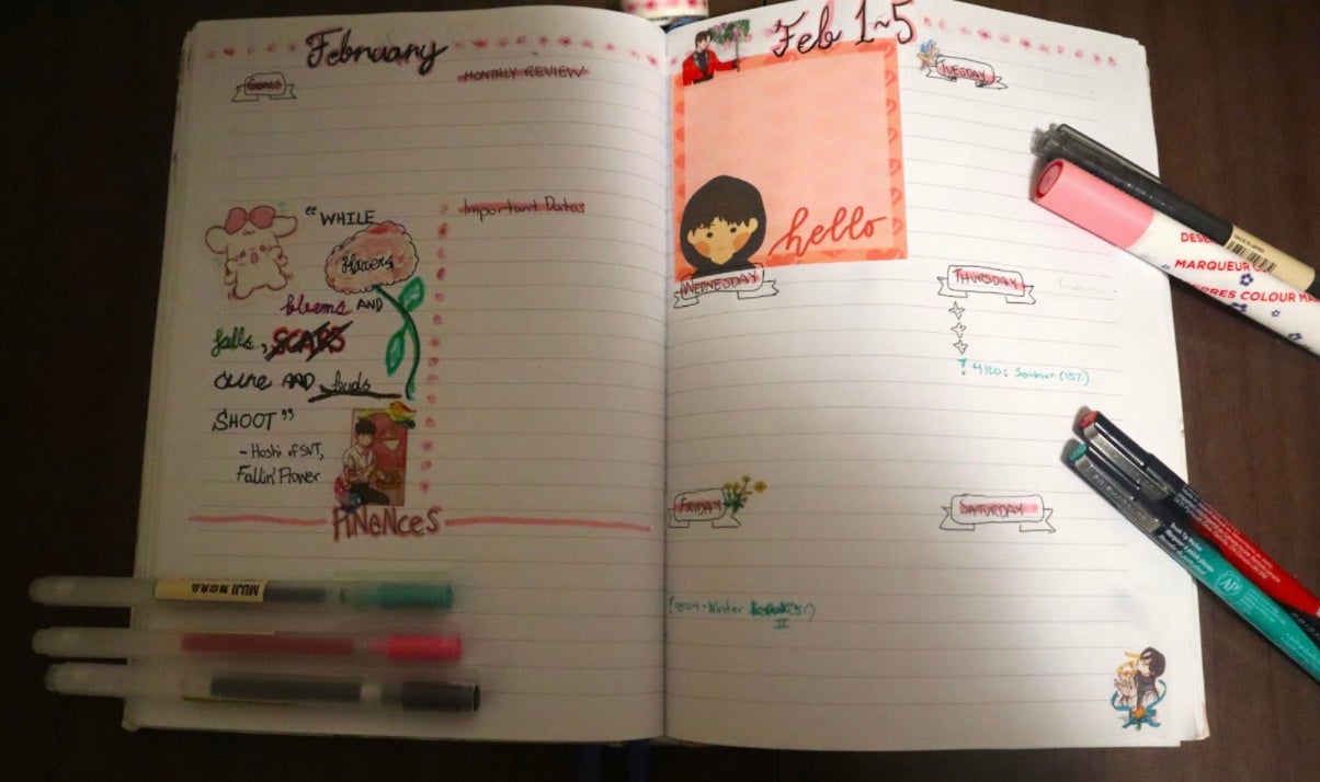 open planner with pens scattered around