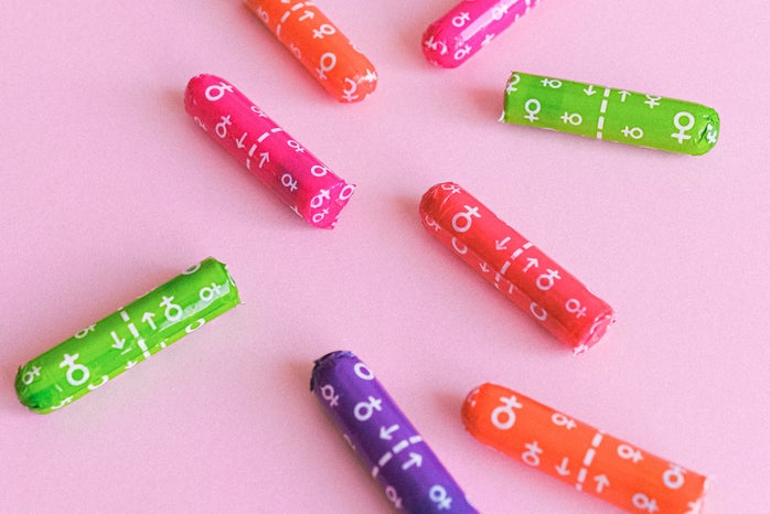 Colorful tampons on a pink background