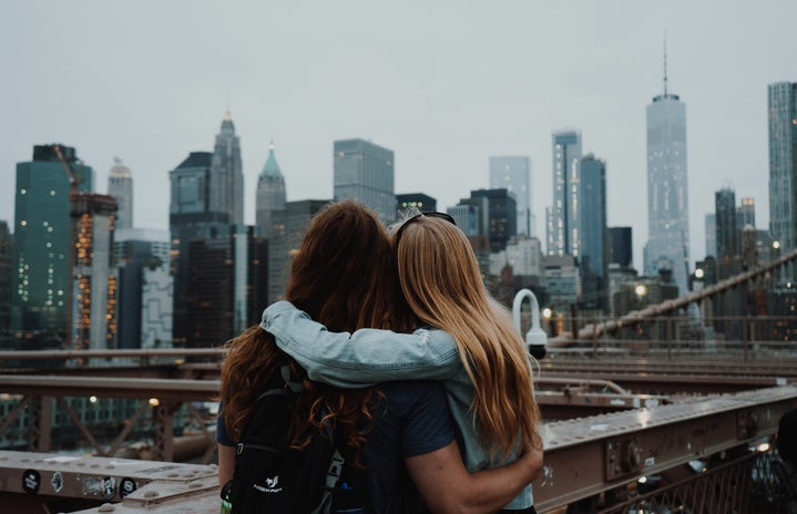 Two girls embracing from behind