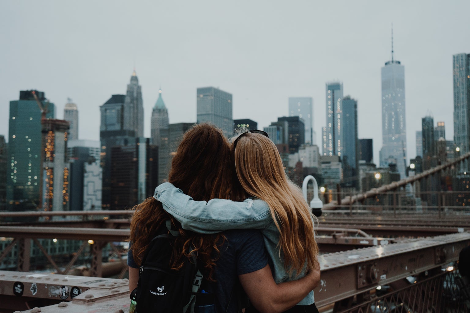 Two girls embracing from behind