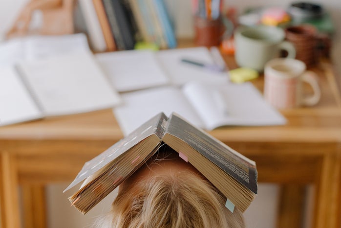 person with book on their head