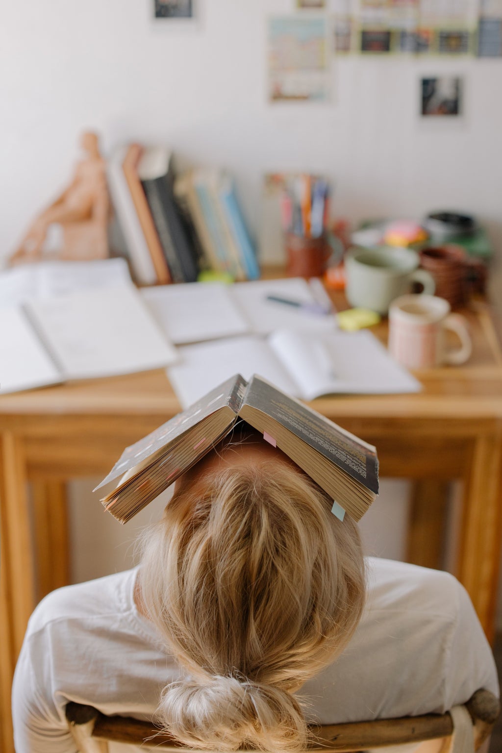 person with book on their head