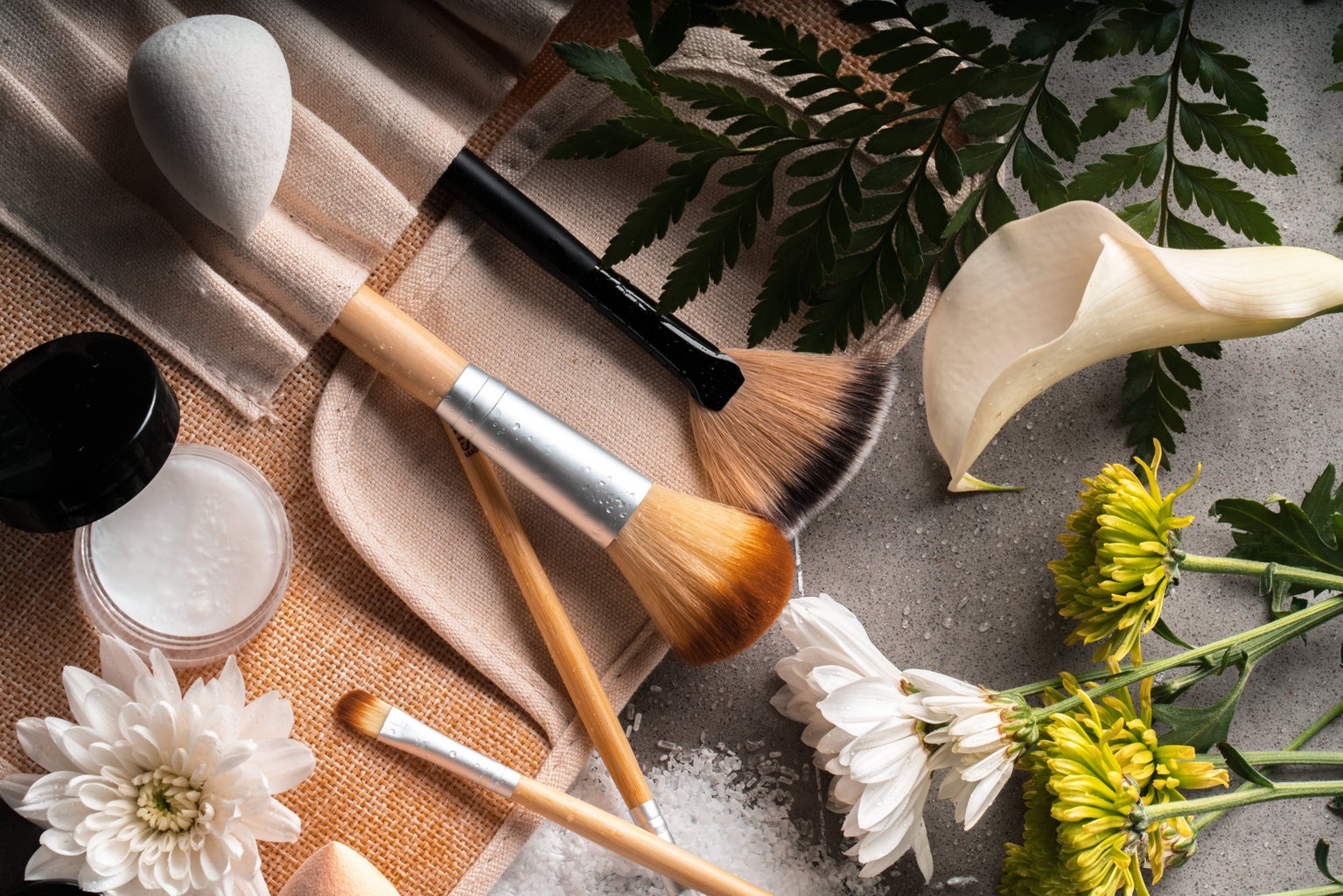 Makeup brushes and flowers