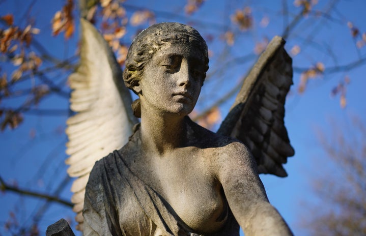 \"angel concrete statue photo\" on unsplash