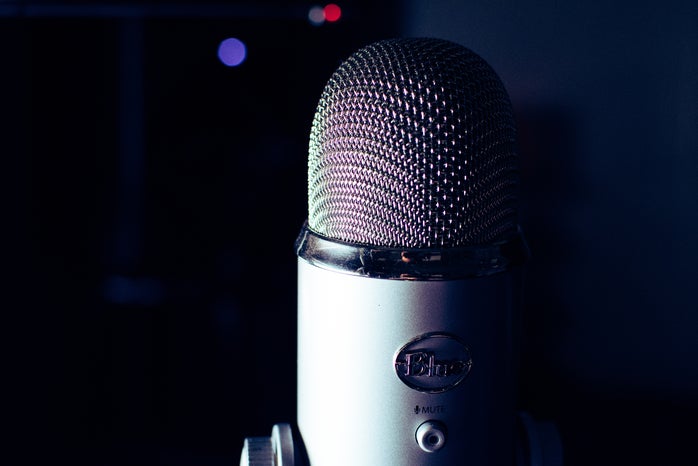 Gray Blue Yeti microphone in dark room