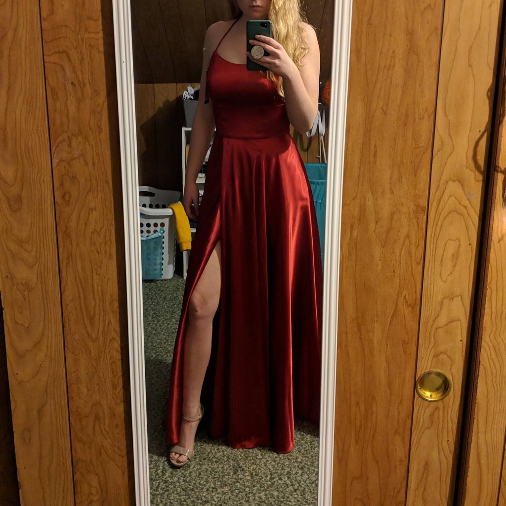 Brianna Strohbehn in her red Prom dress in a mirror.