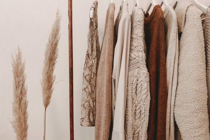 brown and tan clothes hanging on a rack