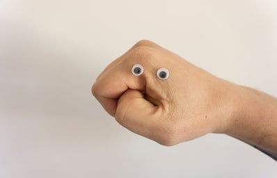 hand with googly eyes stuck to the side of it