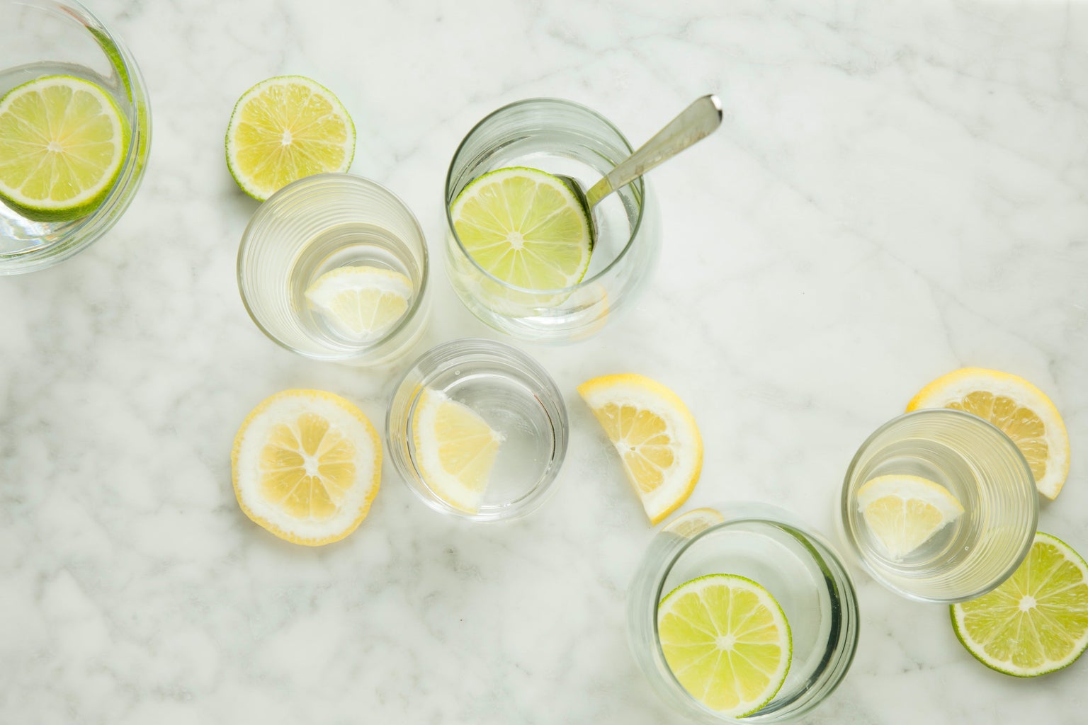 lemon water in glasses on marble countertop