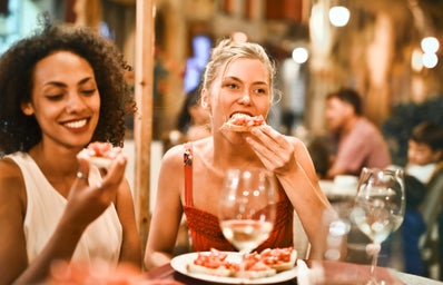 Women eat at a restaurant .