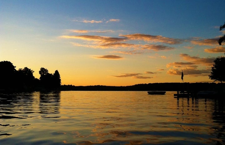 kayaking along a lake during sunset