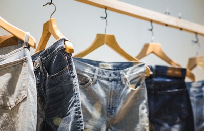 Pairs of jeans hung up on clothing rack