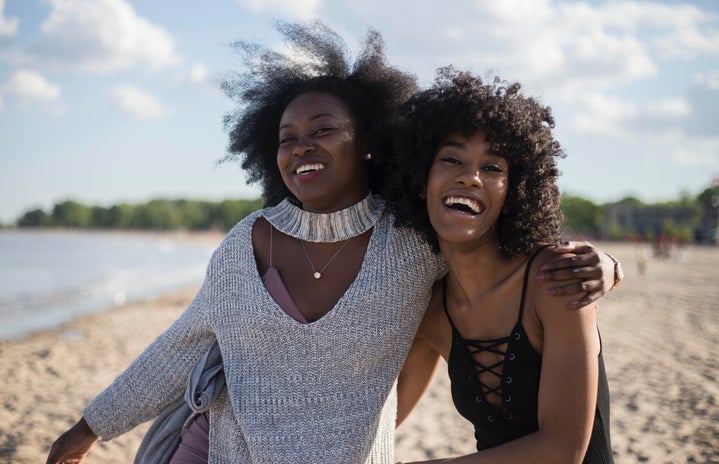 black women smiling on the beach