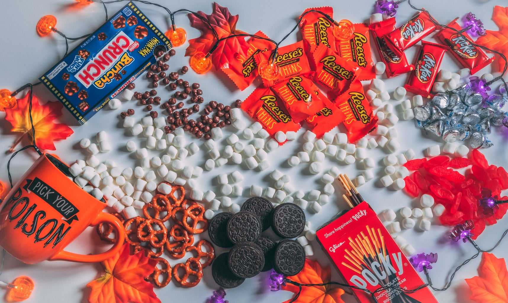 Candy and Halloween decorations are spread across a table.