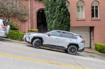 San Francisco, California is very hilly, many streets are quite steep, it takes some skill to properly parallel park the car with front wheels turned to rest on the curb, as seen here in Cow Hollow neighborhood.