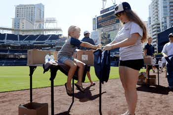 Mother and son making care packages at Petco Park for U.S. troops