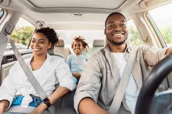 Happy African American Family Riding Car Traveling By Automobile.