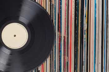 Record placed in front of a vinyl collection