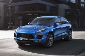 2015 Porsche Macan driving through a city