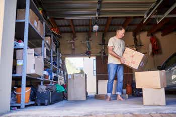 Man going through boxes and items in his garage