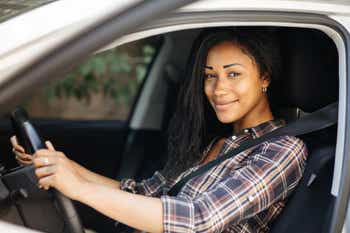 Smiling woman in car drivers seat