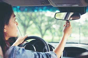 Teen driver checking mirrors
