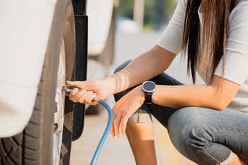 Individual checking their tire pressure and adding air to their tires until they meet their recommended PSI.