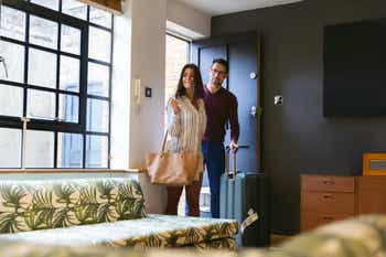 Young couple entering their rented home for a vacation
