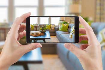 Woman taking home inventory photo with a smartphone