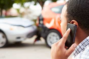 Driver making phone call after traffic accident