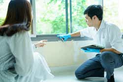 Insurance claim officer talks with customer.