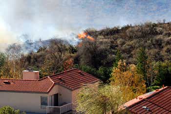 Hill Side on fire near homes 