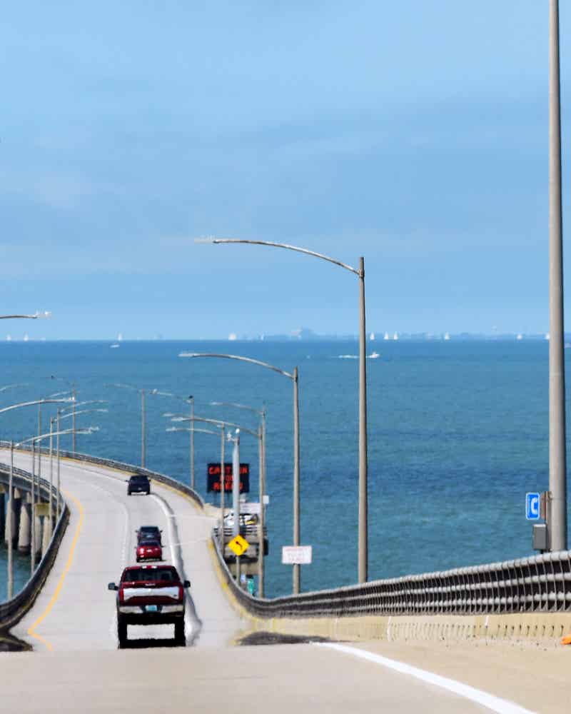 Cars driving through the Chesapeake Bay Bridge Tunnel that connects rural eastern Virginia to urban western Virginia