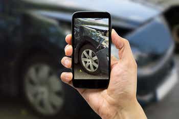 Taking a picture of a wrecked car