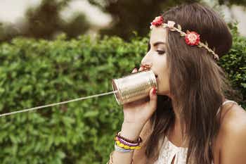 Woman using a tin can phone