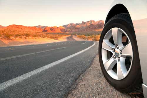 Front end of car on a roadway in Red Rock Canyon.